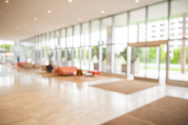 Defocused Modern Corporate Building Lobby Background Out of focus modern corporate lobby with seating area nd windows. chroma key stock pictures, royalty-free photos & images