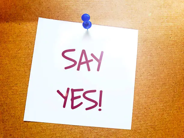 Photo of say yes on white sticky note