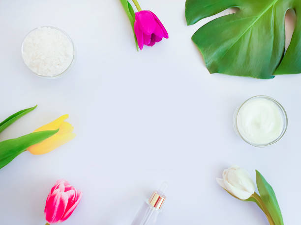 istock cosmetic cream, flower tulip, monstera leaf salt on a colored background 1148272999