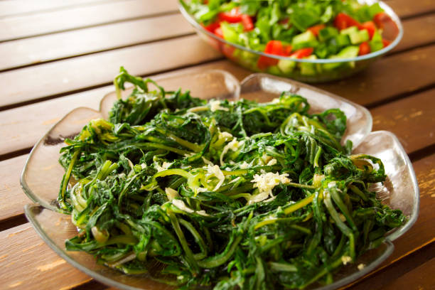 View of a Traditional Mediterranean Vegan Meal; Boiled Wild Sea Radish Sprouts served with Olive Oil, Lemon and Garlic. A tasty inheritance for next generations.