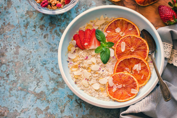 Healthy organic porridge topped with almond,strawberries and blood oranges for the breakfast