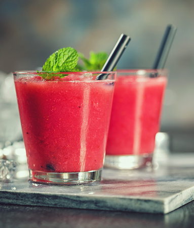 Freshly made watermelon smoothie with ice and mint leaves
