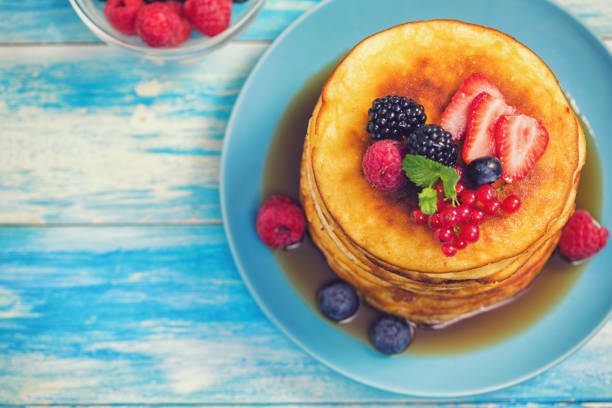 istock Homemade Pancakes with Berries and Maple Syrup 1148276207