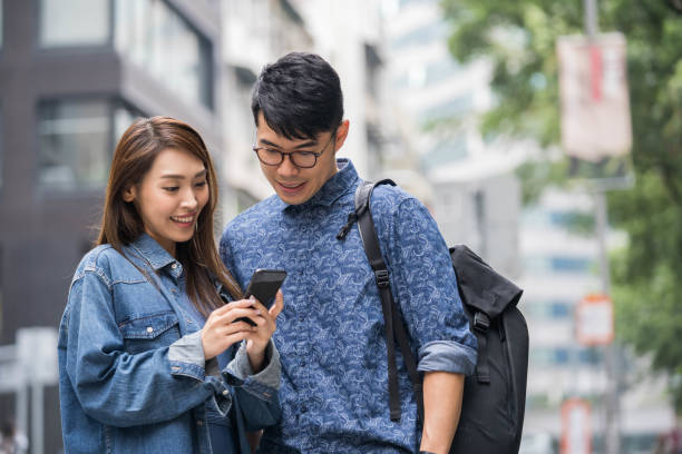 istock Chinese couple using mobile phone app in Hong Kong 1148276994