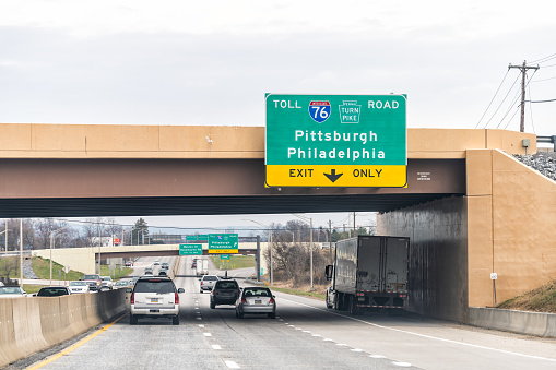 Mechanicsburg, USA - April 6, 2018: Toll 76 turnpike exit only sign on highway 15 in Pennsylvania with cars traffic on cloudy day