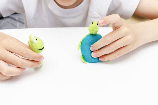 istock A caucasian boy playing different roles by using finger puppets, toys for expressing his emotions, agression, fear and freandship as a part of psychotherapy 1148283997