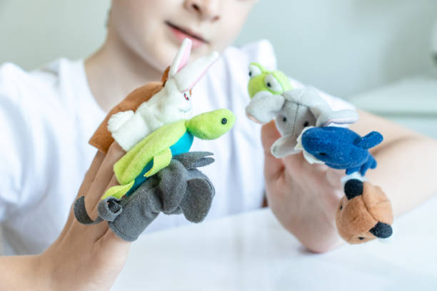 istock A caucasian boy playing different roles by using finger puppets, toys for expressing his emotions, agression, fear and freandship as a part of psychotherapy 1148284045