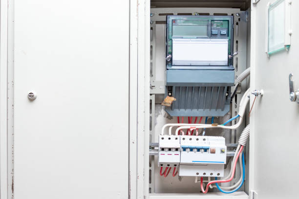 istock Automatic switches with wires and electricity meter in electrical shield close up 1148286364