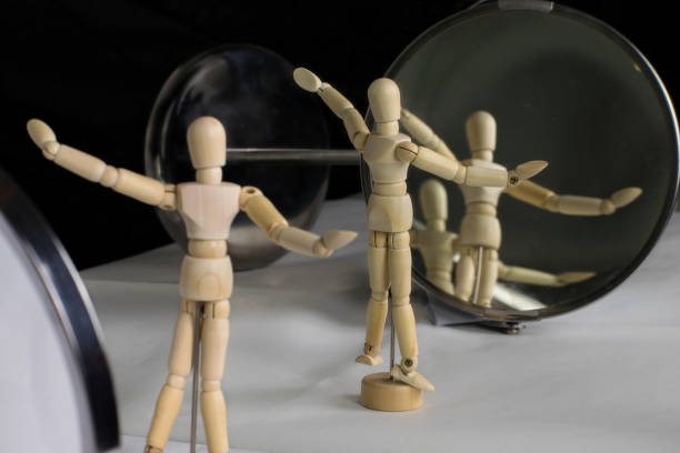 istock mannequin in plastic pose in front of the mirror performs gymnastic exercises 1148288750