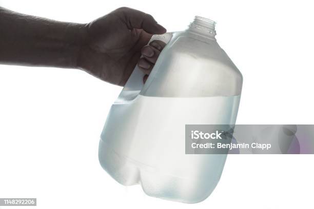 Hand Holding 1 Gallon Plastic Bottle Of Drinking Water Stock Photo - Download Image Now