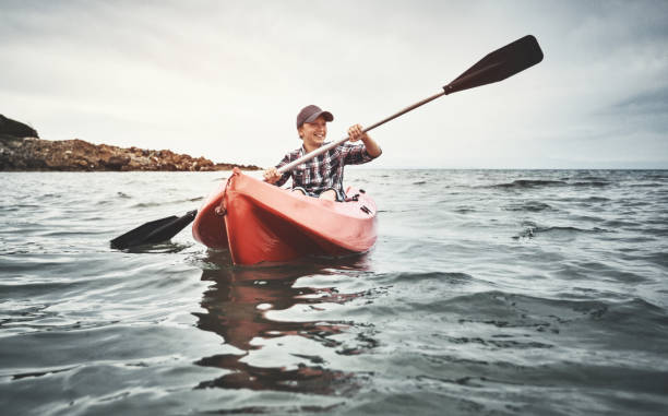 istock Teenage boy canoeing at sunset 1148292955