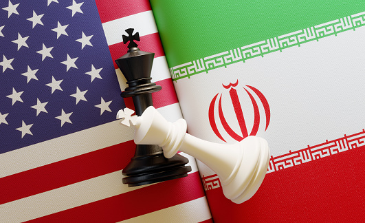 American and Iranian flag pair with king chess pieces on national flags. Horizontal composition with copy space and selective focus.