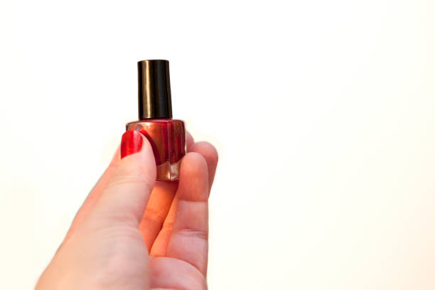 istock Hand holds bottle of red nail polish 1148295727