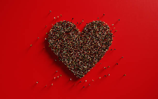 istock Human Crowd Forming A Big Heart Shape On Red Background: Love and Donation Concept 1148297216