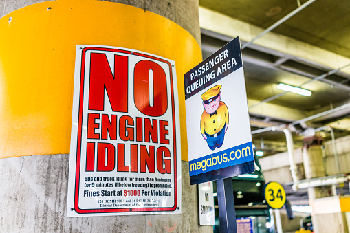 Washington DC, USA - July 1, 2017: Inside Union Station parking garage for buses in capital city with no engine idling sign