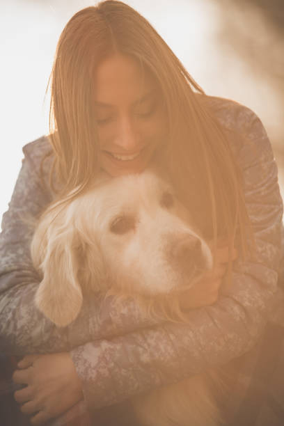 istock Happy woman hugging a golden retriever 1148298322
