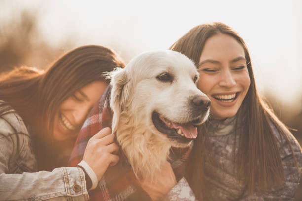 istock Happy women hugging the dog 1148298323