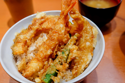 Close up shot of Tempura donburi, plain rice with prawn, veggies and miso soup