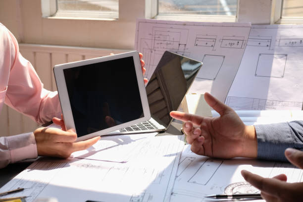 istock architect engineer team working on house blueprint of real estate project at workplace. construction & building concept 1148298711