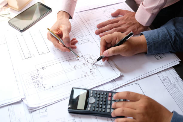 istock architect engineer team working on house blueprint of real estate project at workplace. construction & building concept 1148298727