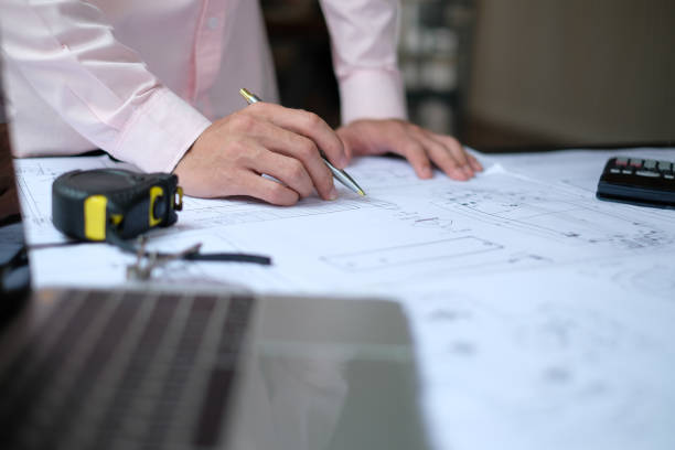 istock architect engineer working on house blueprint of real estate project at workplace. construction & building concept 1148298741