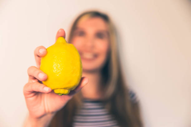 istock Woman holding lemons fruit 1148301516