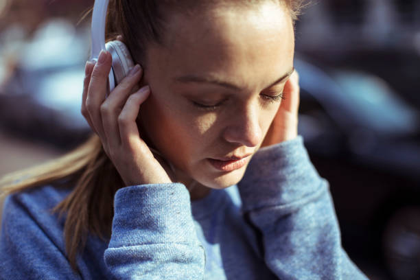 Getting Ready Close up of a woman tying her hair before jogging woman tying hair in ponytail getting ready for exercising stock pictures, royalty-free photos & images