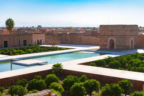A large decorative pool filled with water among the ruins of the El Badi Palace in Marrakech Morocco
