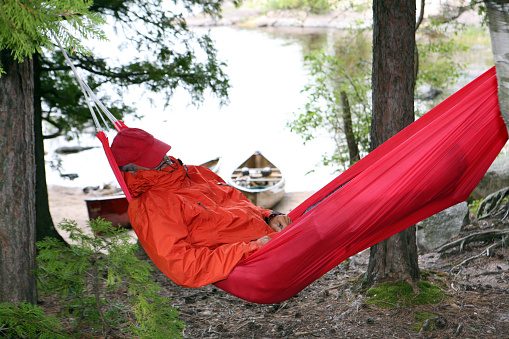 Senior man napping in the Boundary Waters Canoe Area Wilderness. Basswood Lake.