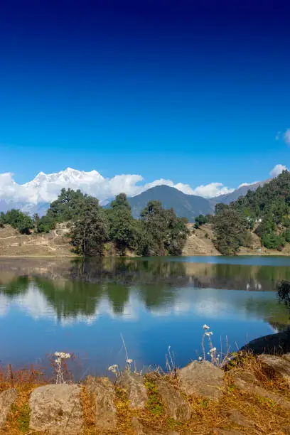 Deoria Tal , also Devaria or Deoriya is a high altitude lake in Uttarakhand, India. Blue sky with snow-covered mountains, Chaukhamba is one of them, in the background. Vertical image.