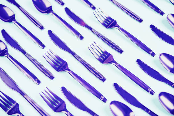 Background with purple forks, knives and spoons