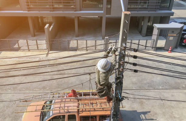 istock Electricians are climbing on electric poles 1148325302