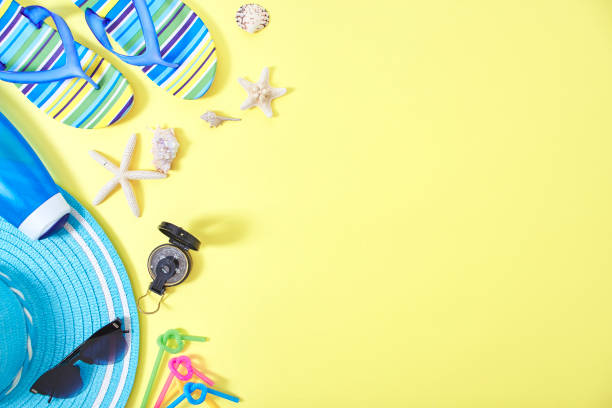 istock Flip-flops and Shower cream with colourful ring floating yellow background with copy space 1148332444