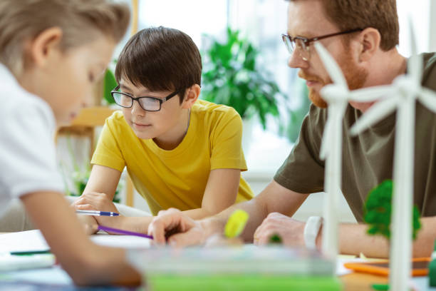 istock Inspired school group with teacher working on recreating poster 1148332753
