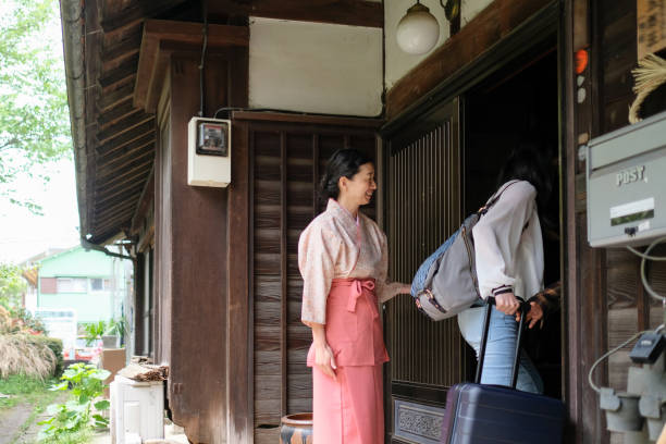 istock Tourist entering into Japanese traditional inn 1148336099