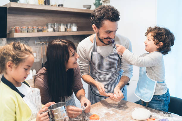 istock Family making cookies in kitchen 1148336511