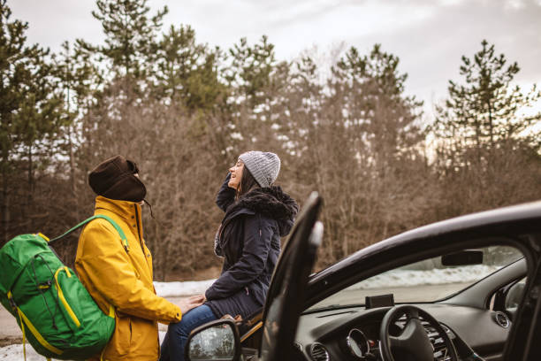 istock Yong couple resting on a car 1148338648