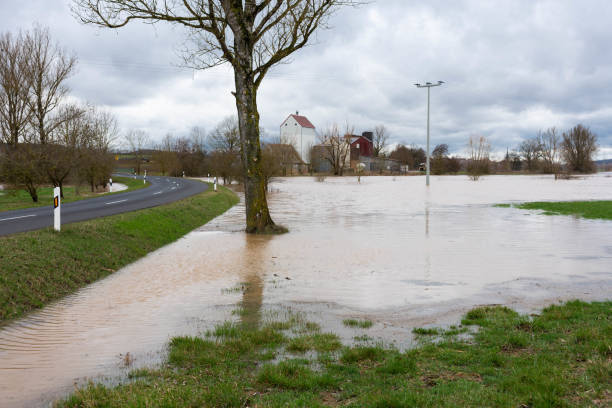 istock High water of a small river near a road 1148341981