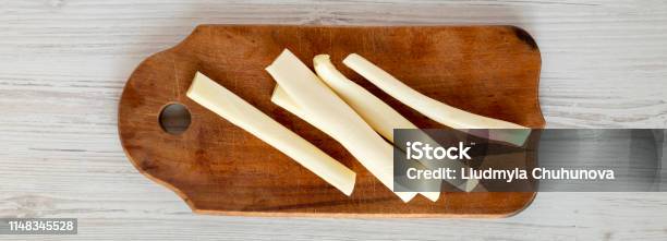String Cheese On Rustic Wooden Board Over White Wooden Background Top View Healthy Snack From Above Overhead Flat Lay Stock Photo - Download Image Now