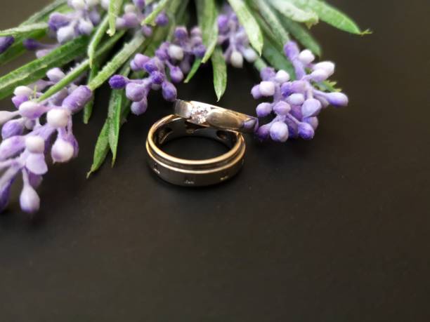 istock Closeup with wedding rings with beautiful roses flower background. 1148345759
