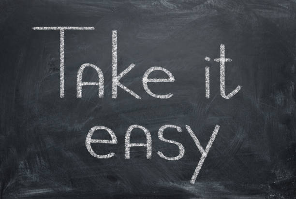 istock Take it easy - inscription in chalk on a blackboard. Relax concept. 1148346959
