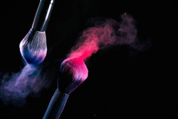 istock Splash of powder on a black background brushes for make up on a black background. 1148347923