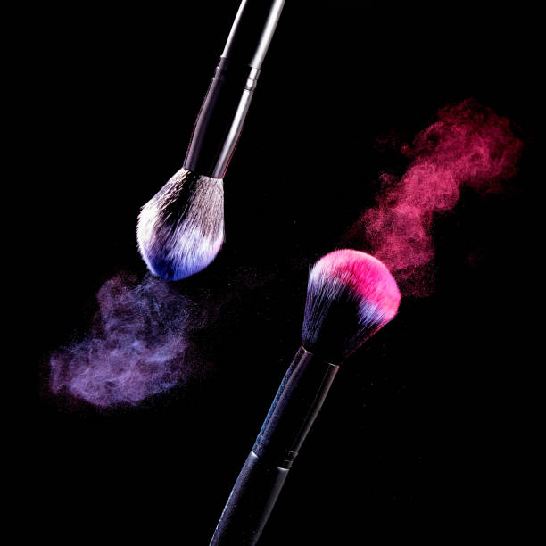 istock Splash of powder on a black background brushes for make up on a black background. 1148347944