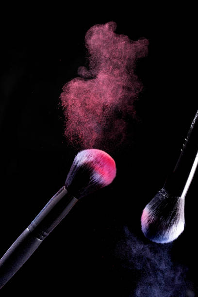 istock Splash of powder on a black background brushes for make up on a black background. 1148347969