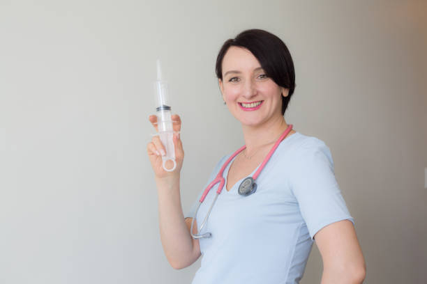 istock Caucasian brunette nurse holding syringe copy space 1148348217