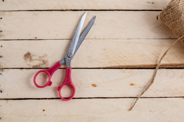 istock vintage scissors and canvas on wooden background. top view 1148349048