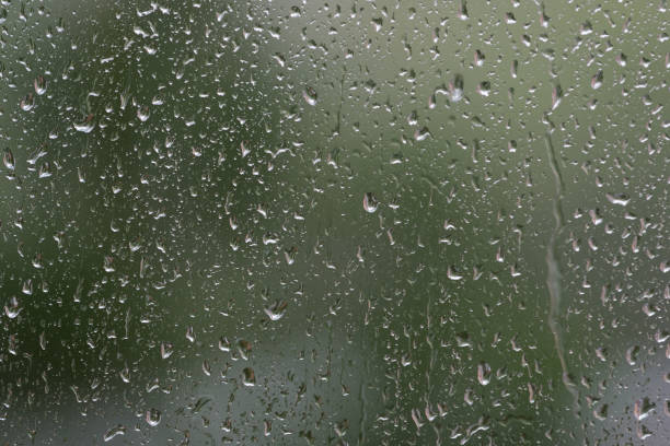 istock Raindrops on window glass during the rain close up. Natural background 1148349315