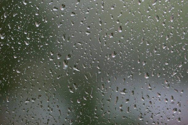 istock Raindrops on window glass during the rain close up. Natural background 1148349316