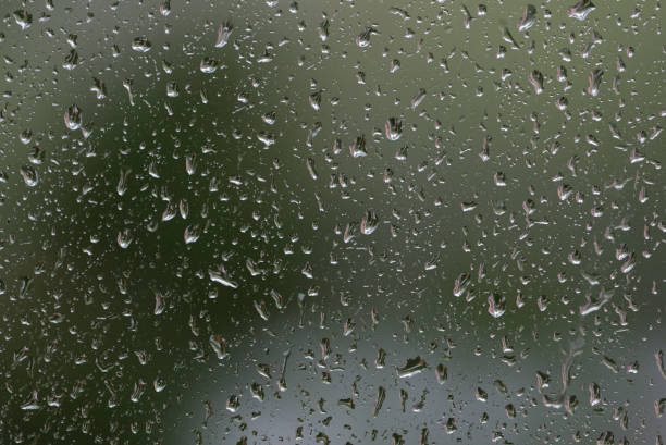 istock Raindrops on window glass during the rain close up. Natural background 1148349343