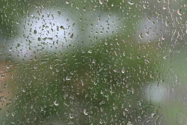 istock Raindrops on window glass during the rain close up. Natural background 1148349345